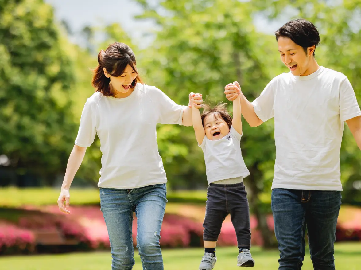 子どもと遊ぶ男性と女性の写真